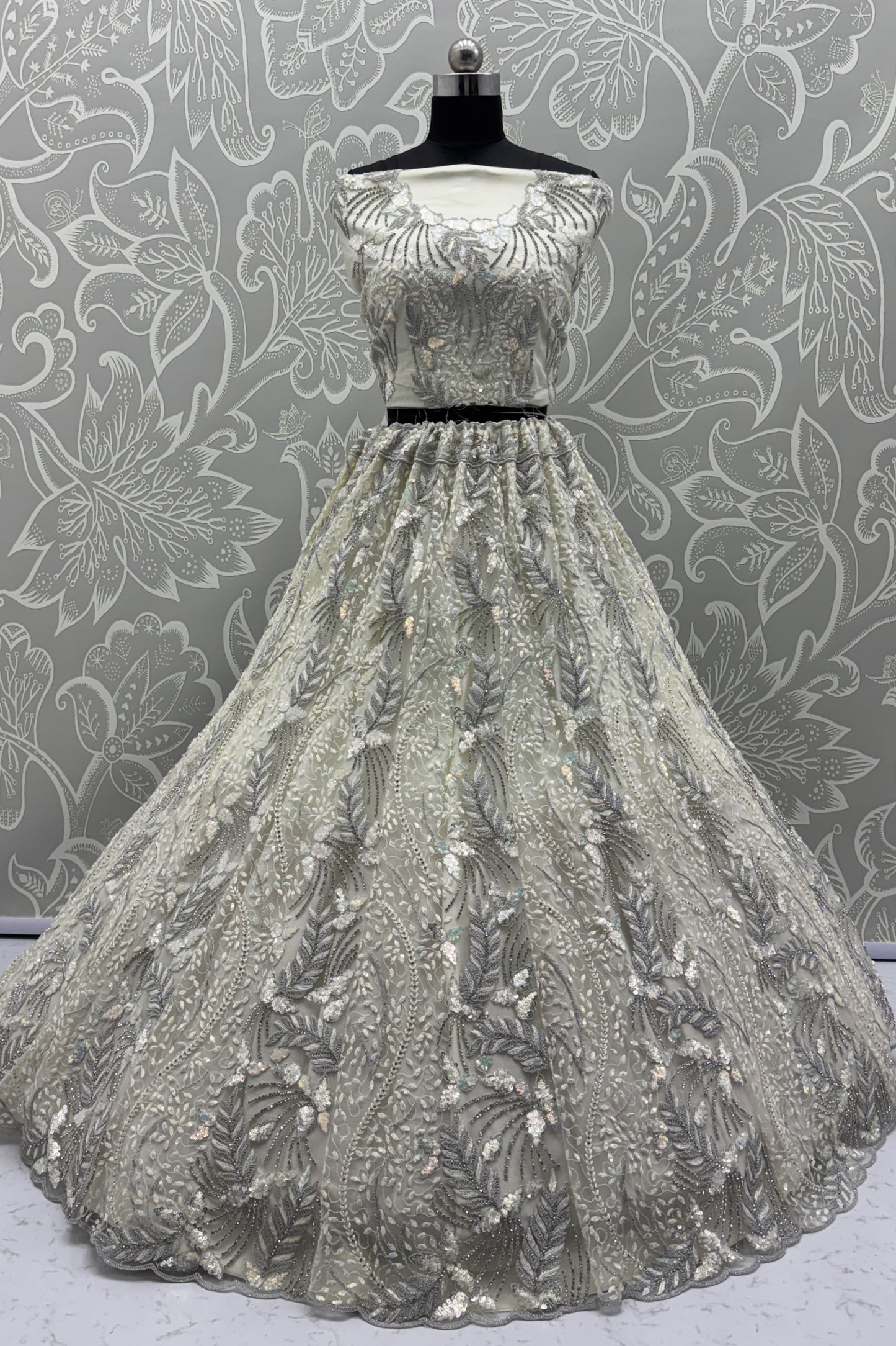 Radiant Off-White Net Bridal Lehenga Choli with Heavy Silver Sequins and Thread Embroidery