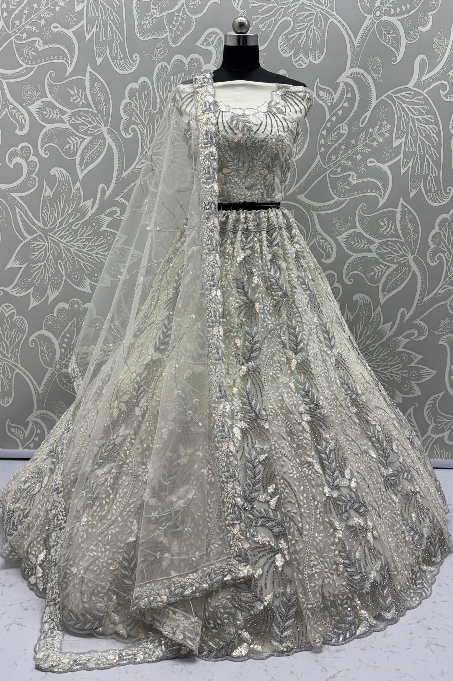 Radiant Off-White Net Bridal Lehenga Choli with Heavy Silver Sequins and Thread Embroidery