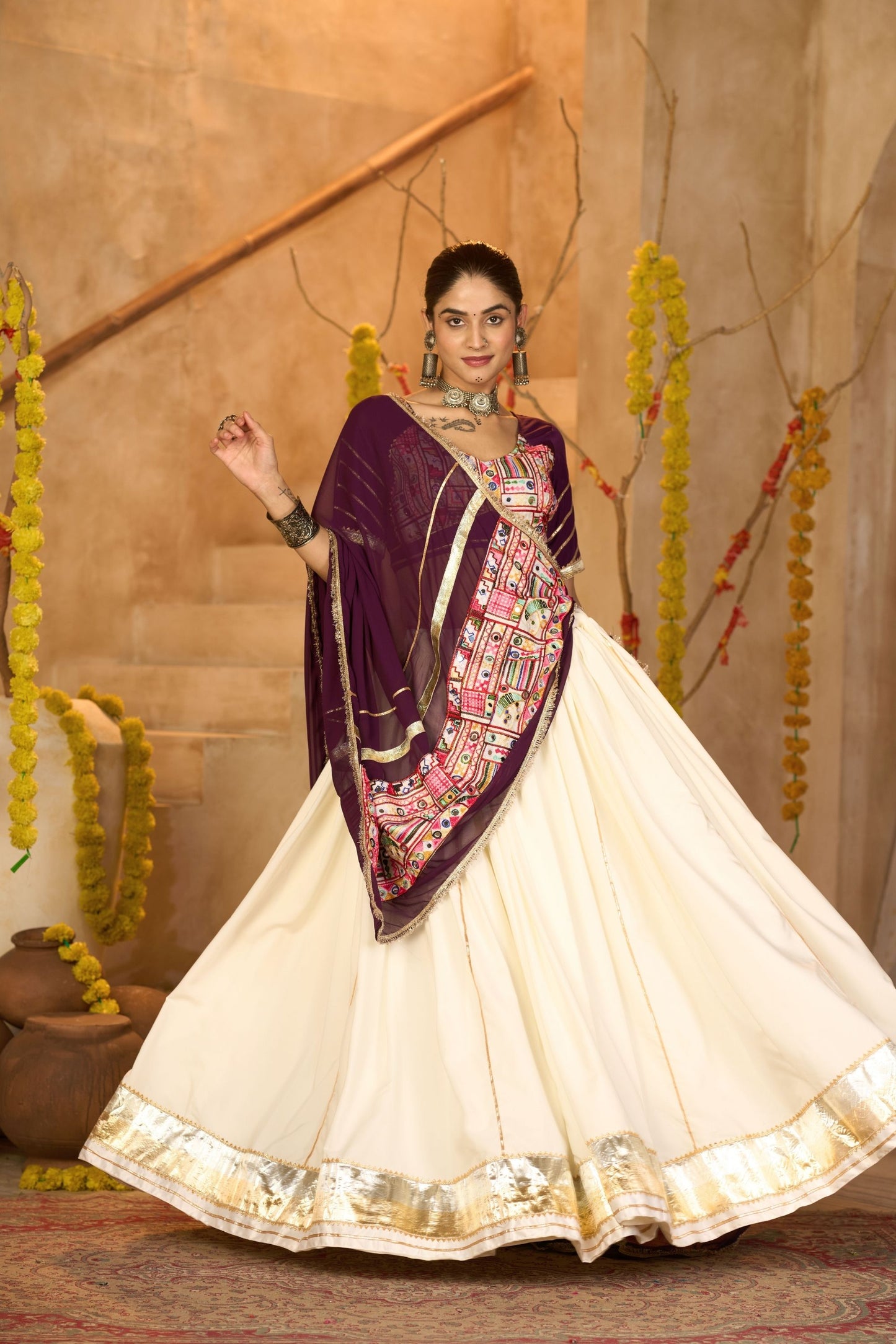 Cream Silk Navratri Lehenga Choli with Gold Zari Border and Purple Dupatta
