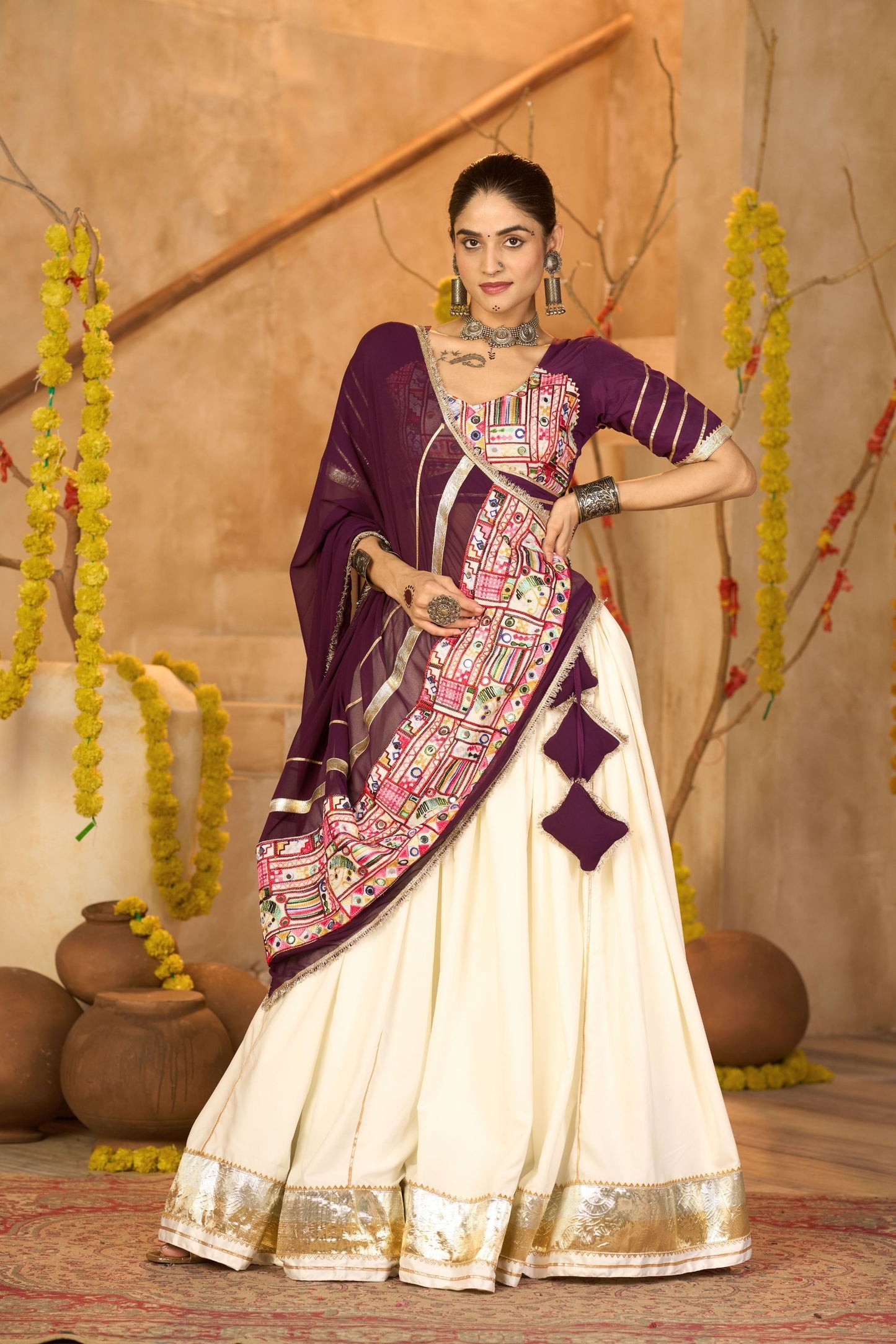 Cream Silk Navratri Lehenga Choli with Gold Zari Border and Purple Dupatta