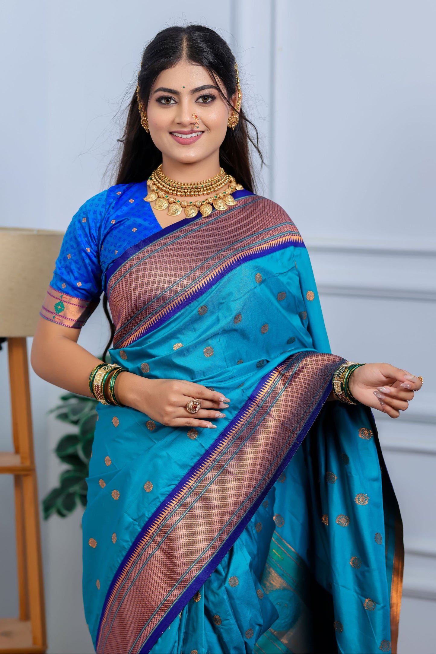 Teal Blue Kanjivaram Silk Saree with Gold Zari Border Butti Work
