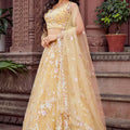 Radiant Yellow Net Embroidered Wedding Lehenga Choli with Floral Thread and Sequins Work
