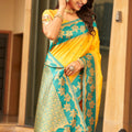 Yellow Silk Saree with Teal Green Contrast Border Floral Zari Work