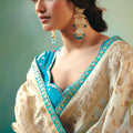 Cream Banarasi Silk Saree with Teal Blue Embroidered Blouse