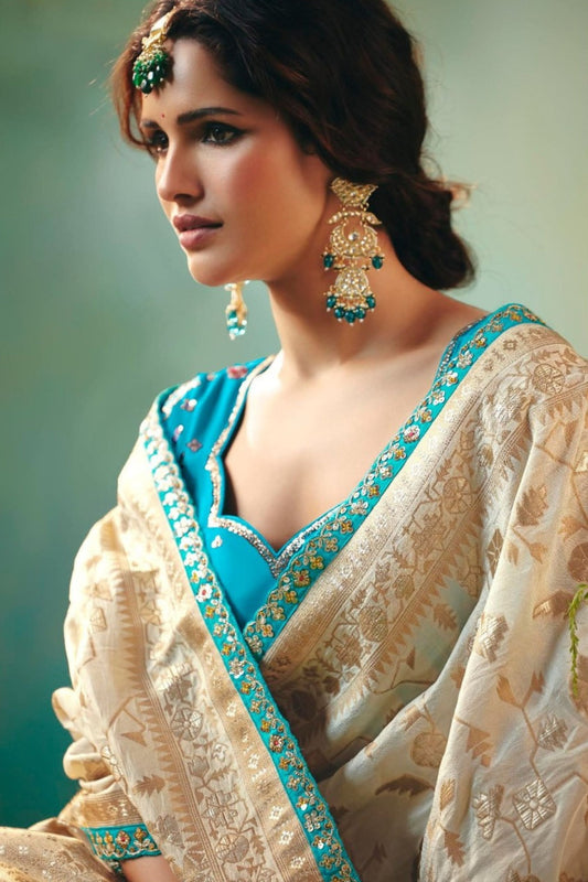 Cream Banarasi Silk Saree with Teal Blue Embroidered Blouse