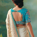 Cream Banarasi Silk Saree with Teal Blue Embroidered Blouse