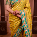 Yellow Silk Saree with Green Border Floral Zari Work Traditional Saree