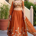 Awesome Rust Orange Rangoli Silk Lehenga Choli with Embroidery Work and Matching Dupatta