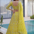 Beautiful Yellow Butterfly Net Heavy Embroidered Bridal Lehenga Choli with Dupatta
