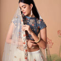 Charming Cream Soft Net Embroidered Lehenga Choli with Grey Blouse and Dupatta