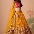 Imperial Mustard Yellow Soft Net Embroidered Lehenga Choli with Red Blouse and Dupatta