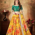 Luxurious Green Embroidered Silk Blouse with Yellow Floral Printed Organza Lehenga Choli