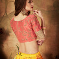 Vibrant Peach Embroidered Silk Blouse with Yellow Floral Printed Organza Lehenga Choli