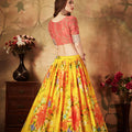 Vibrant Peach Embroidered Silk Blouse with Yellow Floral Printed Organza Lehenga Choli