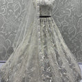 Radiant Off-White Net Bridal Lehenga Choli with Heavy Silver Sequins and Thread Embroidery