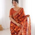 Rust Orange Georgette Leaf Print Saree with Golden Embroidered Border