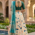 Stylish Cream Art Silk Embroidered Lehenga Choli with Teal Green Blouse and Dupatta