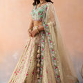 Stunning Cream Embroidered Lehenga Choli with Mint Green Blouse and Net Dupatta
