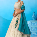 Traditional Cream Semi-Stitched Embroidered Lehenga Choli with Teal Green Dupatta