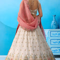Lovable Cream Semi-Stitched Embroidered Lehenga Choli with Pink Dupatta