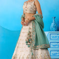 Beautiful Cream Semi-Stitched Embroidered Lehenga Choli with Sea Green Dupatta