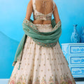 Beautiful Cream Semi-Stitched Embroidered Lehenga Choli with Sea Green Dupatta