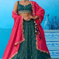 Luxurious Dark Green Cosmos Silk Embroidered Lehenga Choli with Pink Dupatta