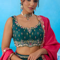 Luxurious Dark Green Cosmos Silk Embroidered Lehenga Choli with Pink Dupatta