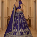 Majestic Dark Purple Silk Embroidered Lehenga Choli with Peacock Motif Border and Designer Dupatta
