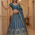 Exquisite Sky Blue Silk Embroidered Lehenga Choli with Peacock Motif Border and Designer Dupatta