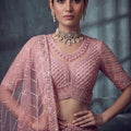 Impressive Dusty Rose Pink Net Lehenga Choli with Heavy Embroidery Work for Wedding