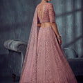 Impressive Dusty Rose Pink Net Lehenga Choli with Heavy Embroidery Work for Wedding