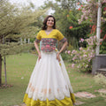 Impressive White and Yellow Roman Silk Navratri Lehenga Choli with Kutchi Gamthi Embroidery Work
