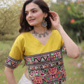 Impressive White and Yellow Roman Silk Navratri Lehenga Choli with Kutchi Gamthi Embroidery Work