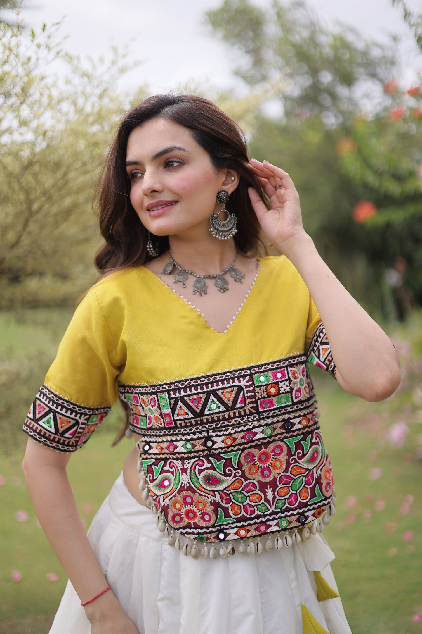 Impressive White and Yellow Roman Silk Navratri Lehenga Choli with Kutchi Gamthi Embroidery Work