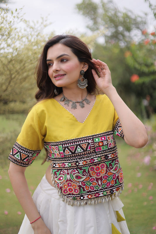 Impressive White and Yellow Roman Silk Navratri Lehenga Choli with Kutchi Gamthi Embroidery Work