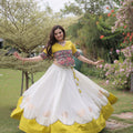 Impressive White and Yellow Roman Silk Navratri Lehenga Choli with Kutchi Gamthi Embroidery Work
