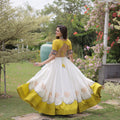 Impressive White and Yellow Roman Silk Navratri Lehenga Choli with Kutchi Gamthi Embroidery Work