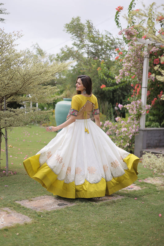 Impressive White and Yellow Roman Silk Navratri Lehenga Choli with Kutchi Gamthi Embroidery Work