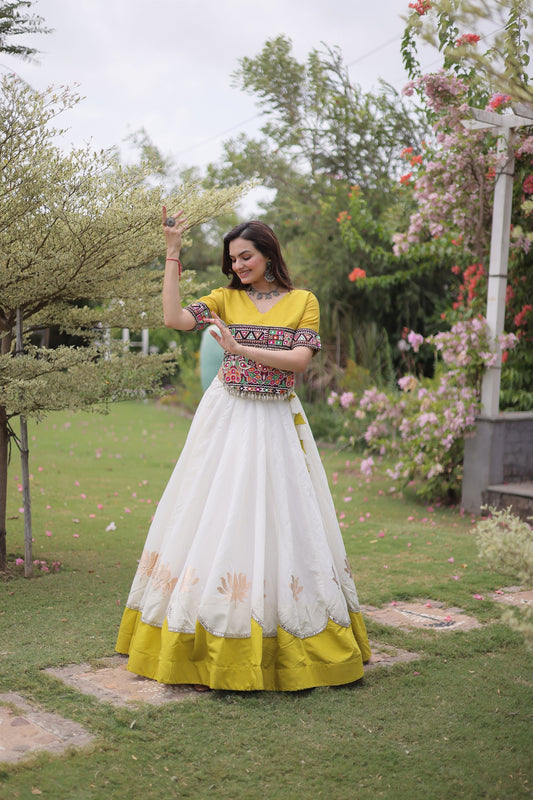 Impressive White and Yellow Roman Silk Navratri Lehenga Choli with Kutchi Gamthi Embroidery Work