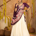 Cream Silk Navratri Lehenga Choli with Gold Zari Border and Purple Dupatta