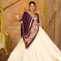 Cream Silk Navratri Lehenga Choli with Gold Zari Border and Purple Dupatta