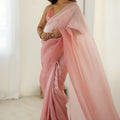 Elegant Peach Organza Saree with Minimal Texture Tassel Border