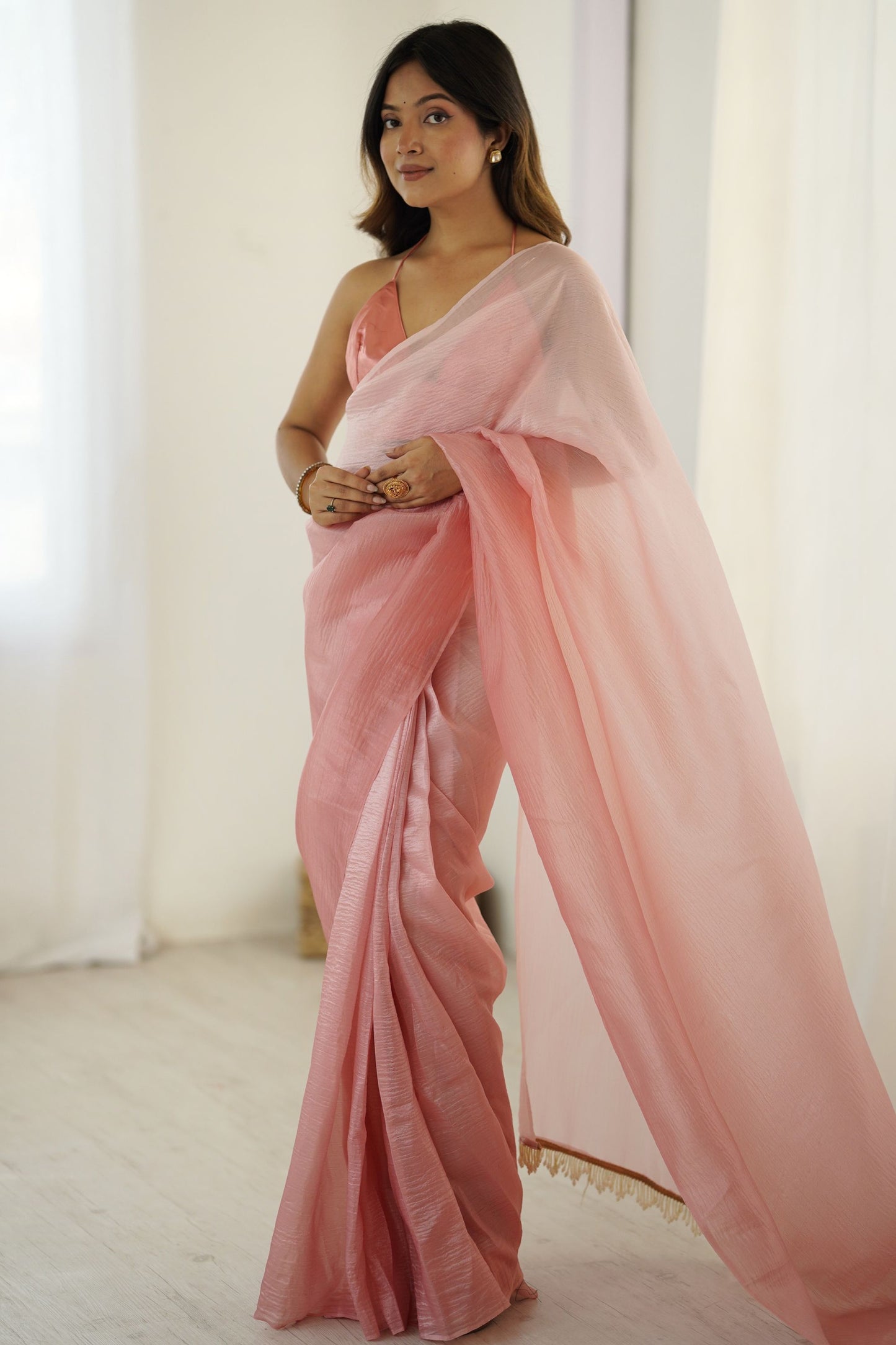 Elegant Peach Organza Saree with Minimal Texture Tassel Border
